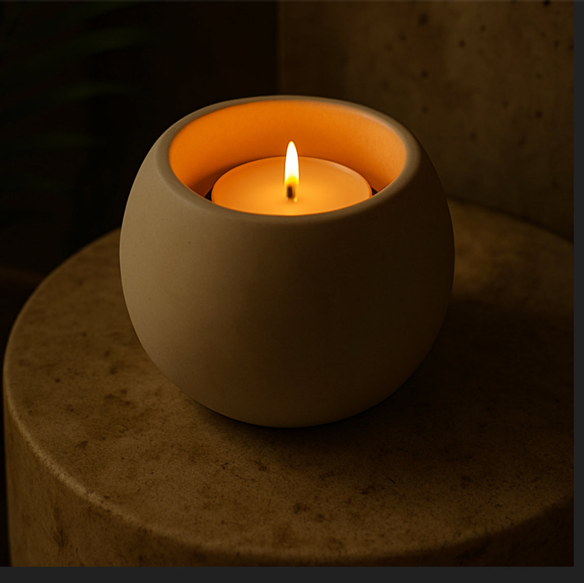 Minimalist dark grey handcast T-light holder styled in evening light