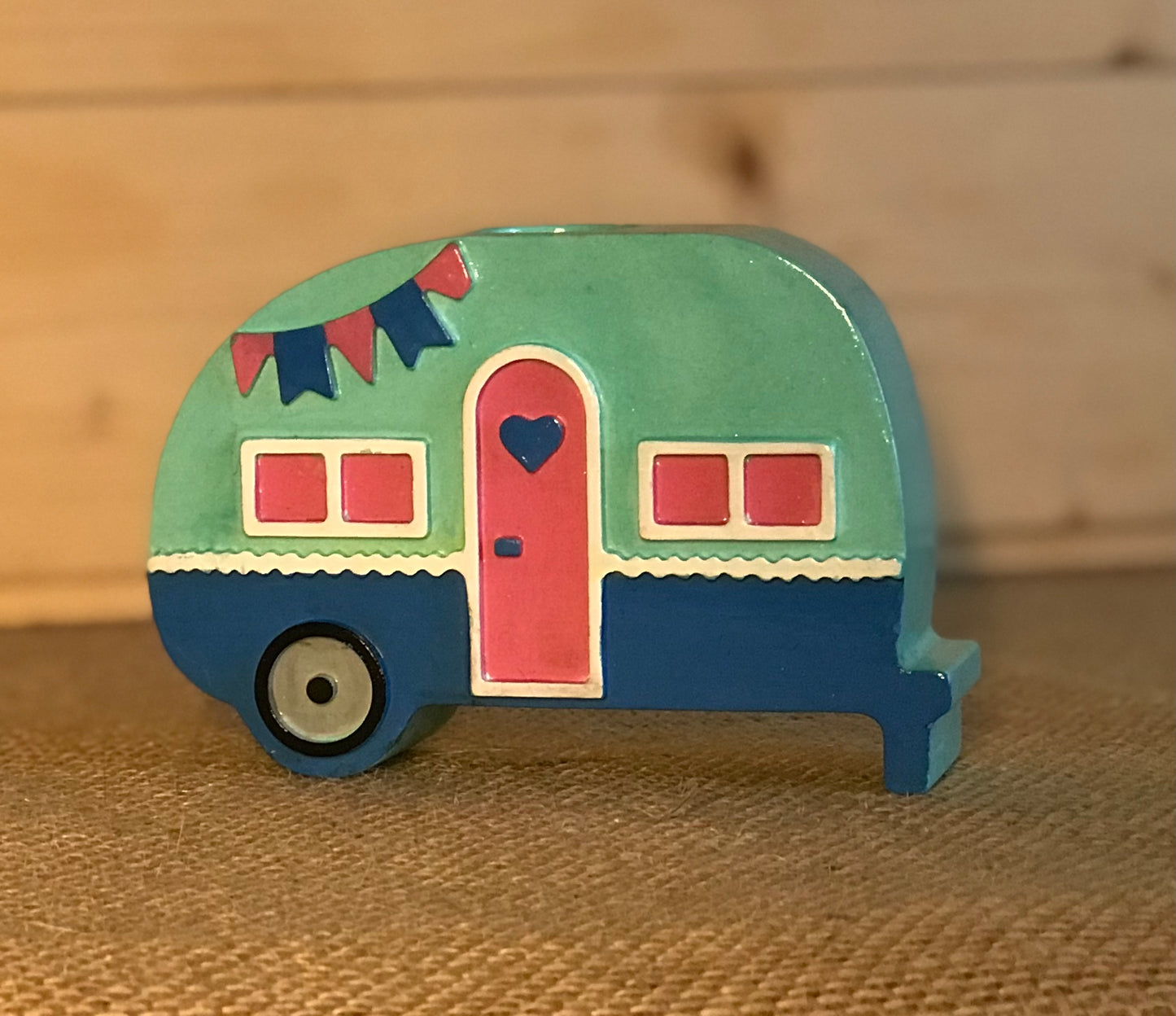 Campervan candle holder placed on a shelf with coastal-themed decor, highlighting its suitability for boho or seaside-inspired interiors.