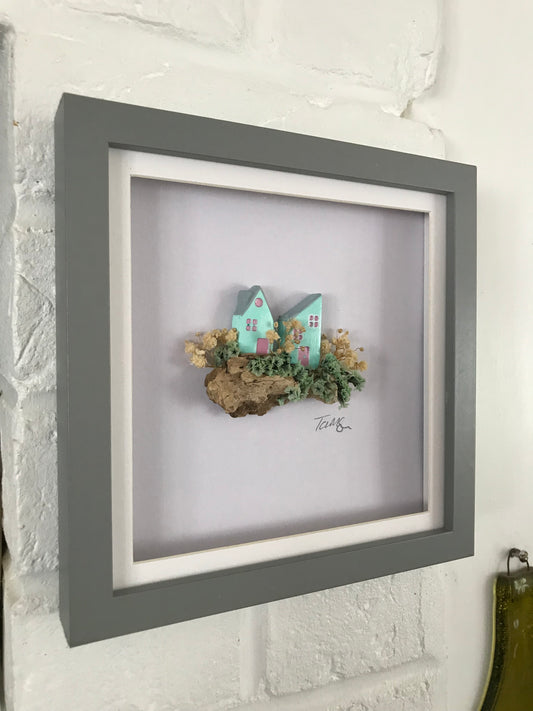 Miniature Turquoise Clay Houses Art – Framed Driftwood Scene with Wild Flowers (18x18cm)