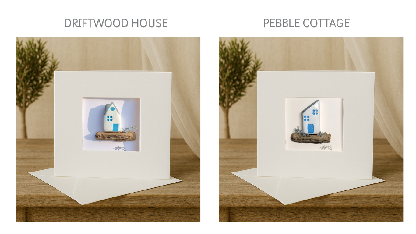 Two handmade coastal cottage cards side-by-side, each featuring a unique white and blue house design on natural driftwood.