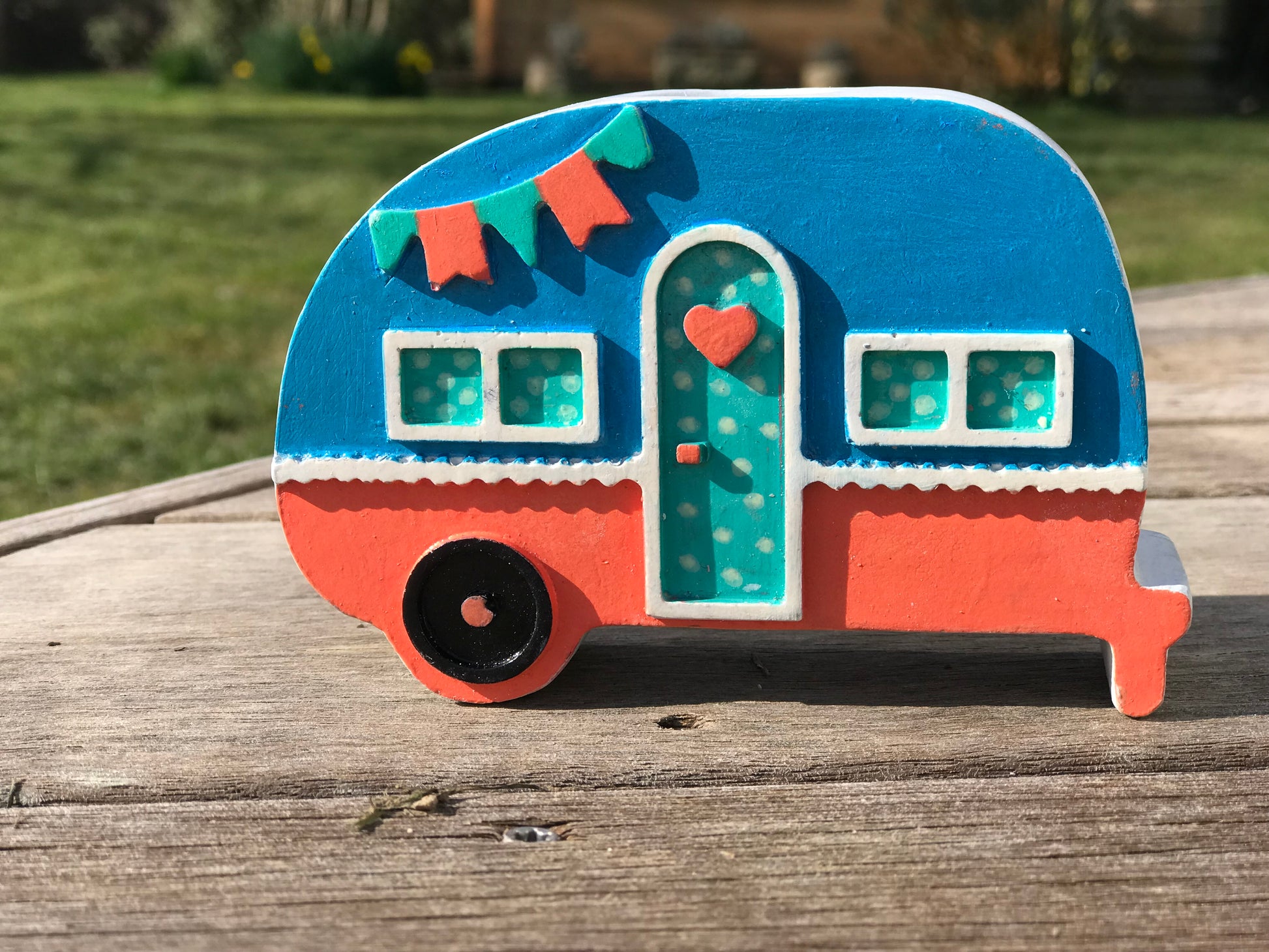 Campervan candle holder in  Orange & blue colorway with a green polka dot door, showcasing the customizable color options available.
