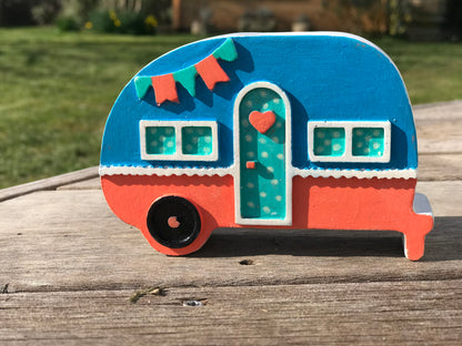 Campervan candle holder in  Orange & blue colorway with a green polka dot door, showcasing the customizable color options available.