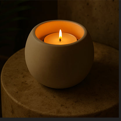 Minimalist dark grey handcast T-light holder styled in evening light