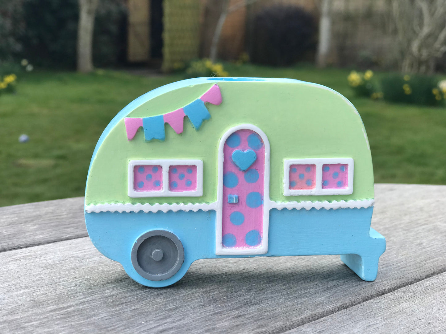 Campervan candle holder in baby blue and green colorway with pink door, showcasing the customizable color options available.