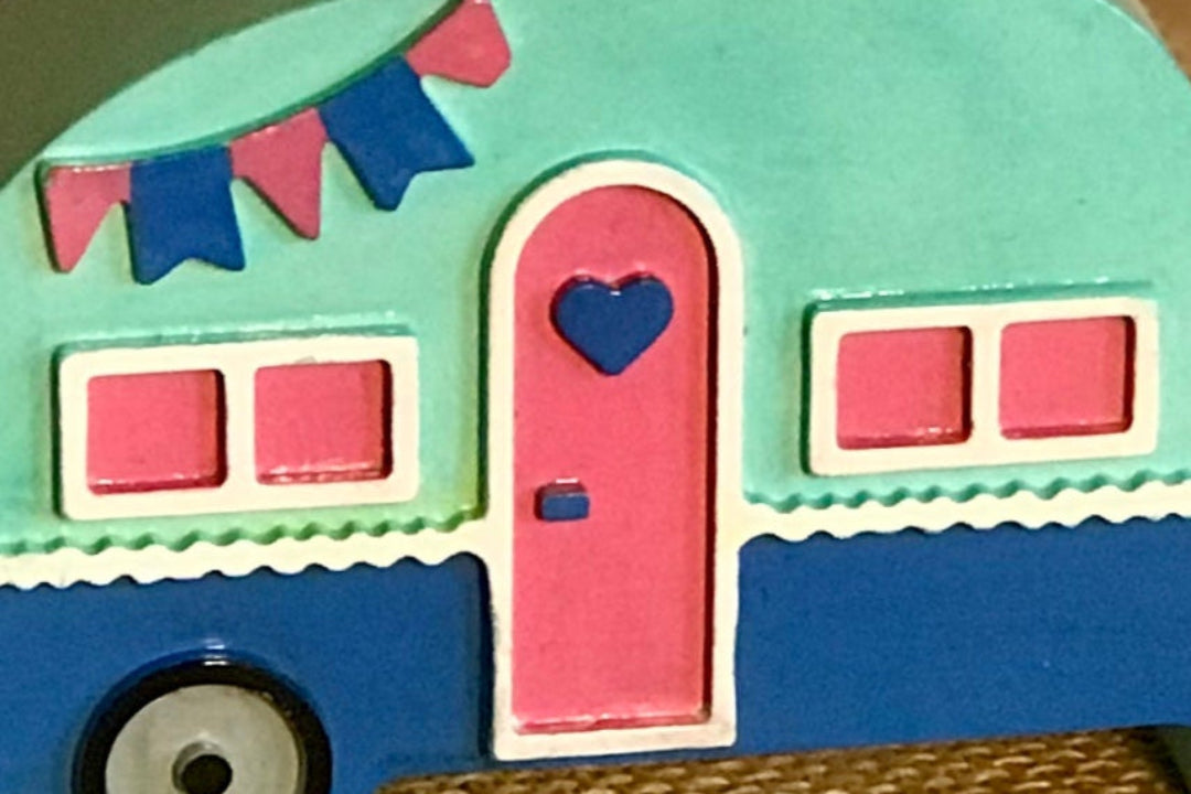 Close-up of the campervan candle holder's hand-painted bunting and window details, emphasizing the craftsmanship and glossy ceramic finish.
