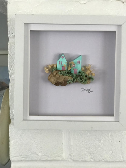 Miniature Turquoise Clay Houses Art – Framed Driftwood Scene with Wild Flowers (18x18cm)