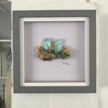 Miniature Turquoise Clay Houses Art – Framed Driftwood Scene with Wild Flowers (18x18cm)